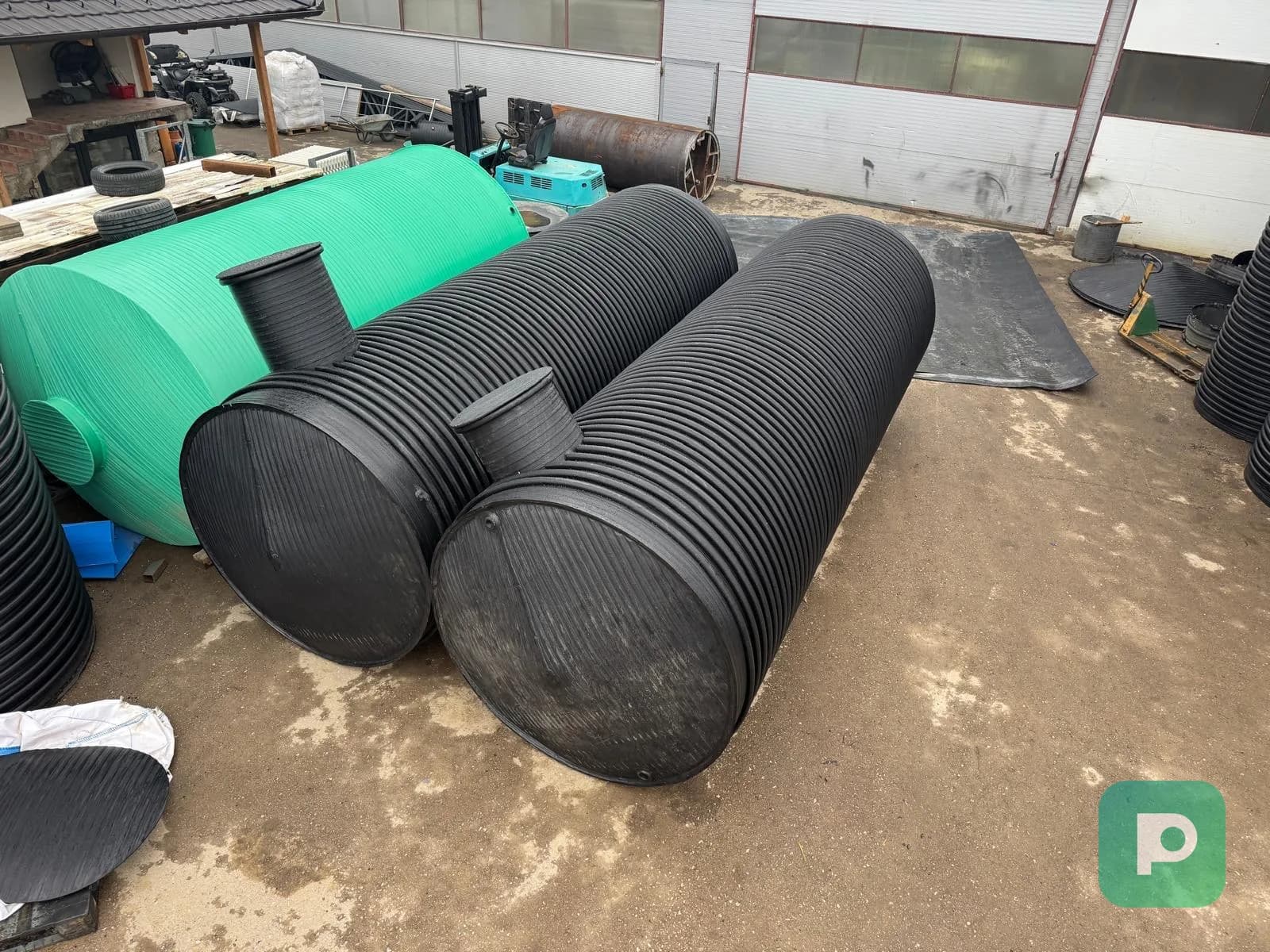 Black horizontal Plastopex plastic tanks with inspection openings in the production plant