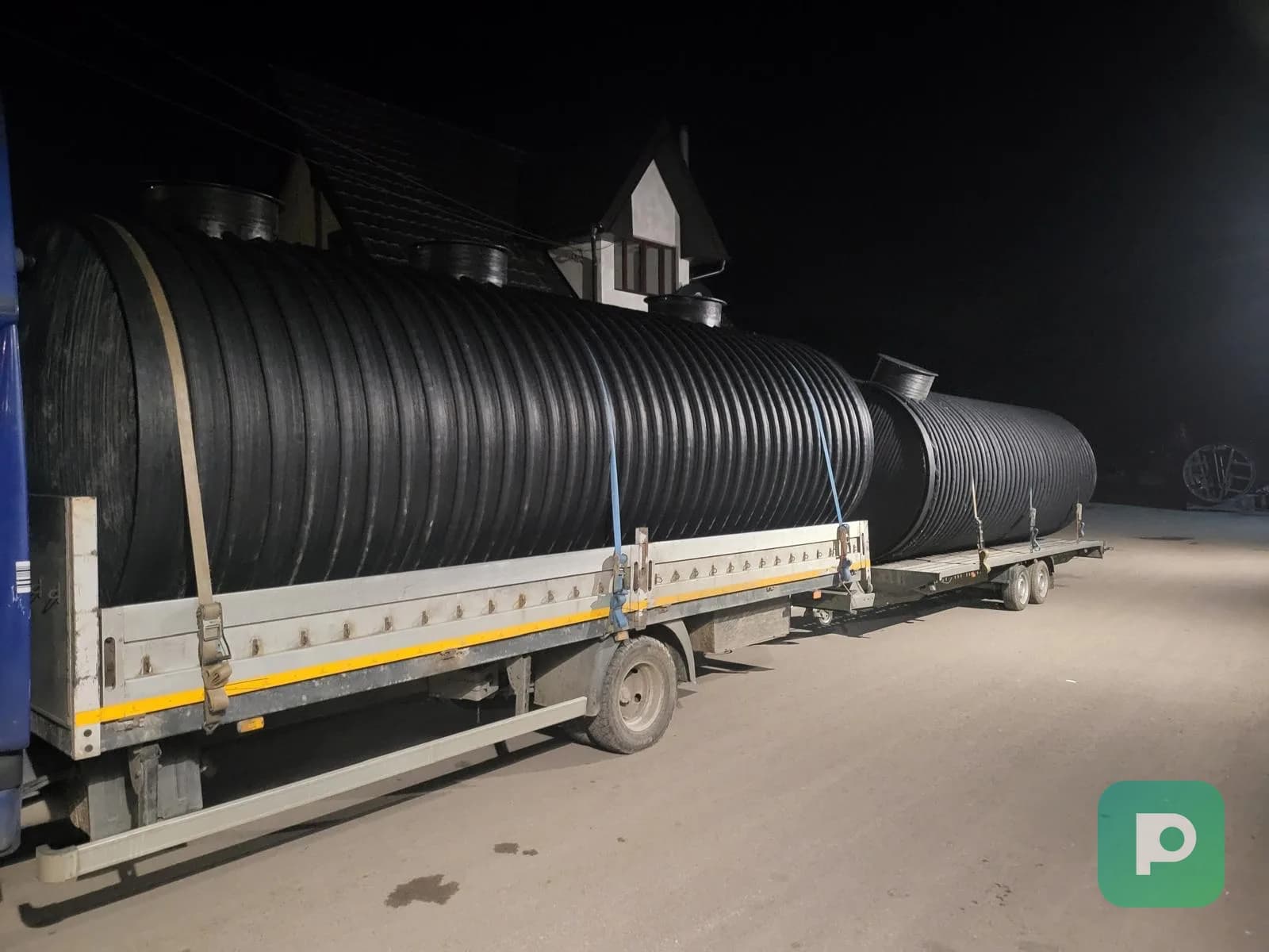 Large horizontal Plastopex plastic tanks being transported by truck to the customer's site